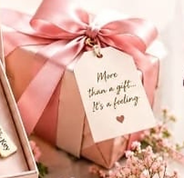 Blush gift box tied with a pink satin bow and a tag reading More than a gift, it is a feeling